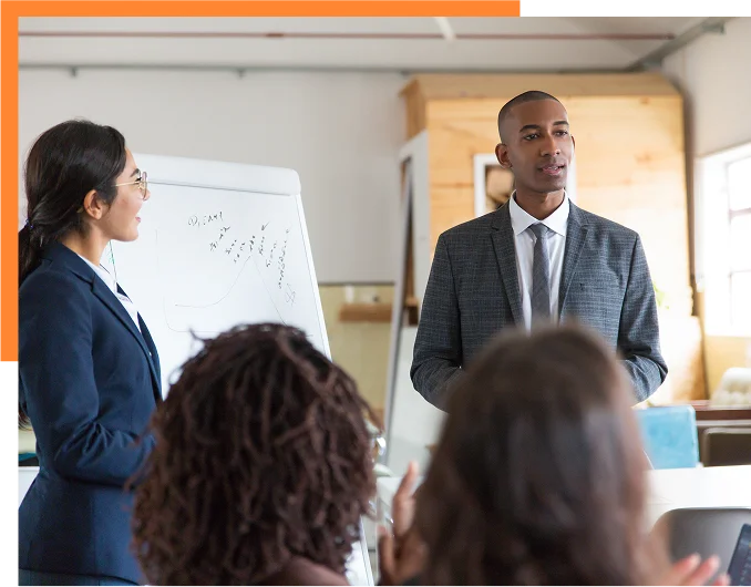 Cheerful young speakers standing near whiteboard