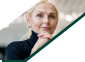 Stoic older business woman posing while working and having coffee